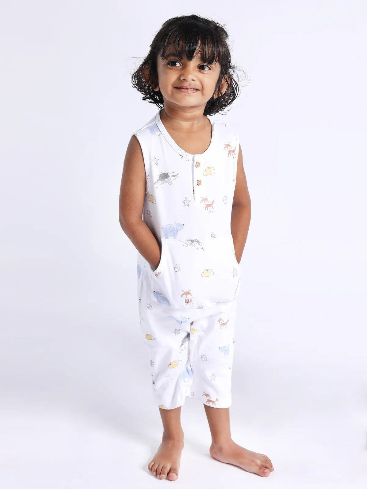 Sleeveless white & graphic pattern dungaree for baby girls