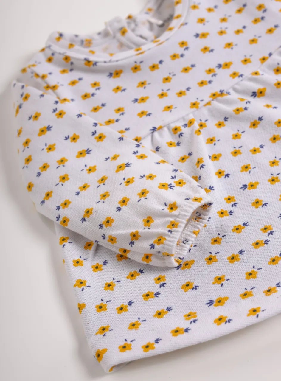 Full sleeve yellow flower pattern in white frock for baby girls
